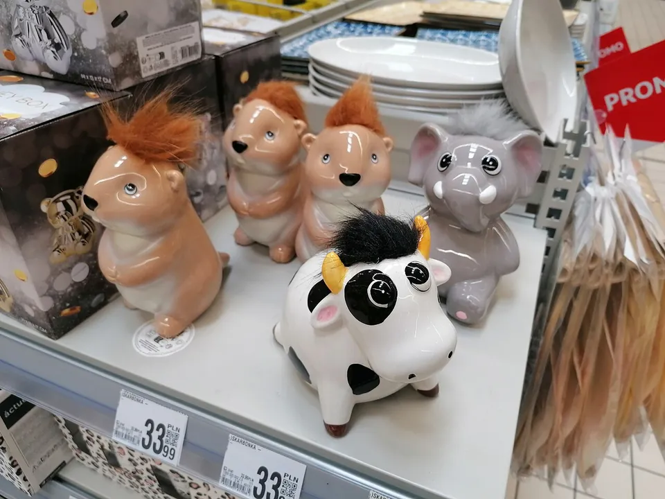 Ceramic piggy banks in animal shapes on a store shelf